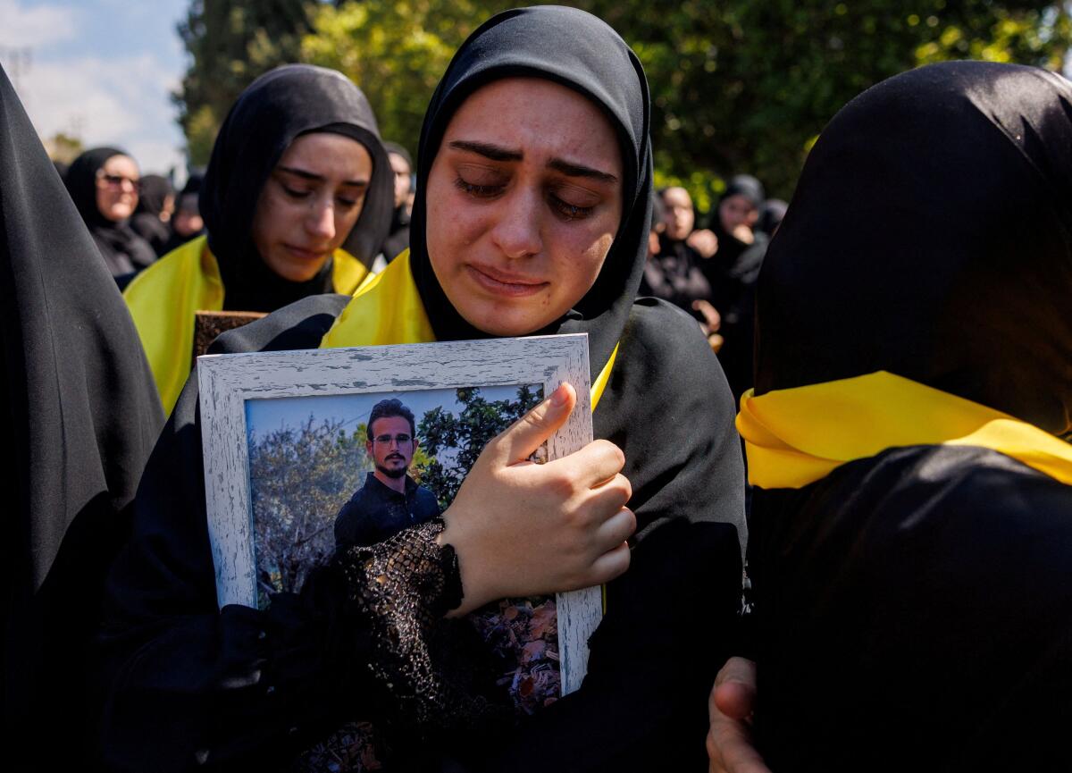 A woman mourns her relative Ali Ballout, a civil defence member killed during the conflict with Israel.