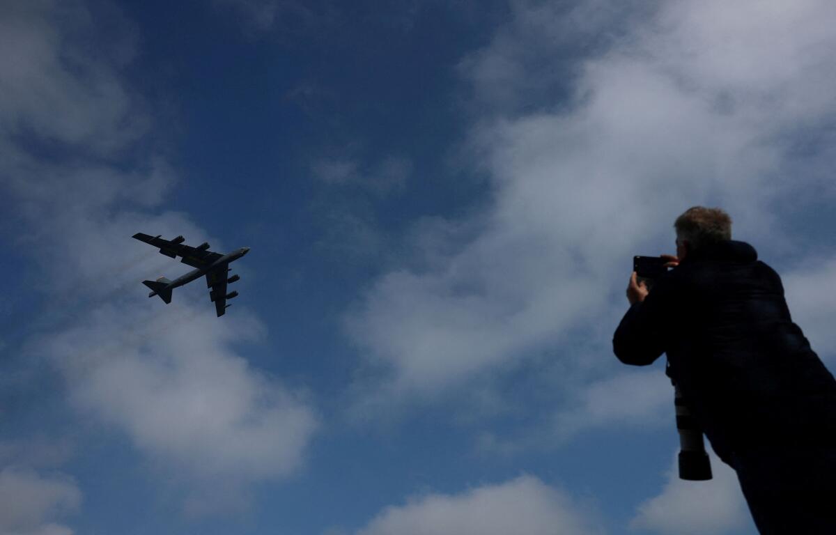 A plane spotter watches as a Boeing B-52 Stratofortress takes off at RAF Fairford airbase, which hosts United States Air Force (USAF) personnel, amid a ceasefire between the United States and Iran.
