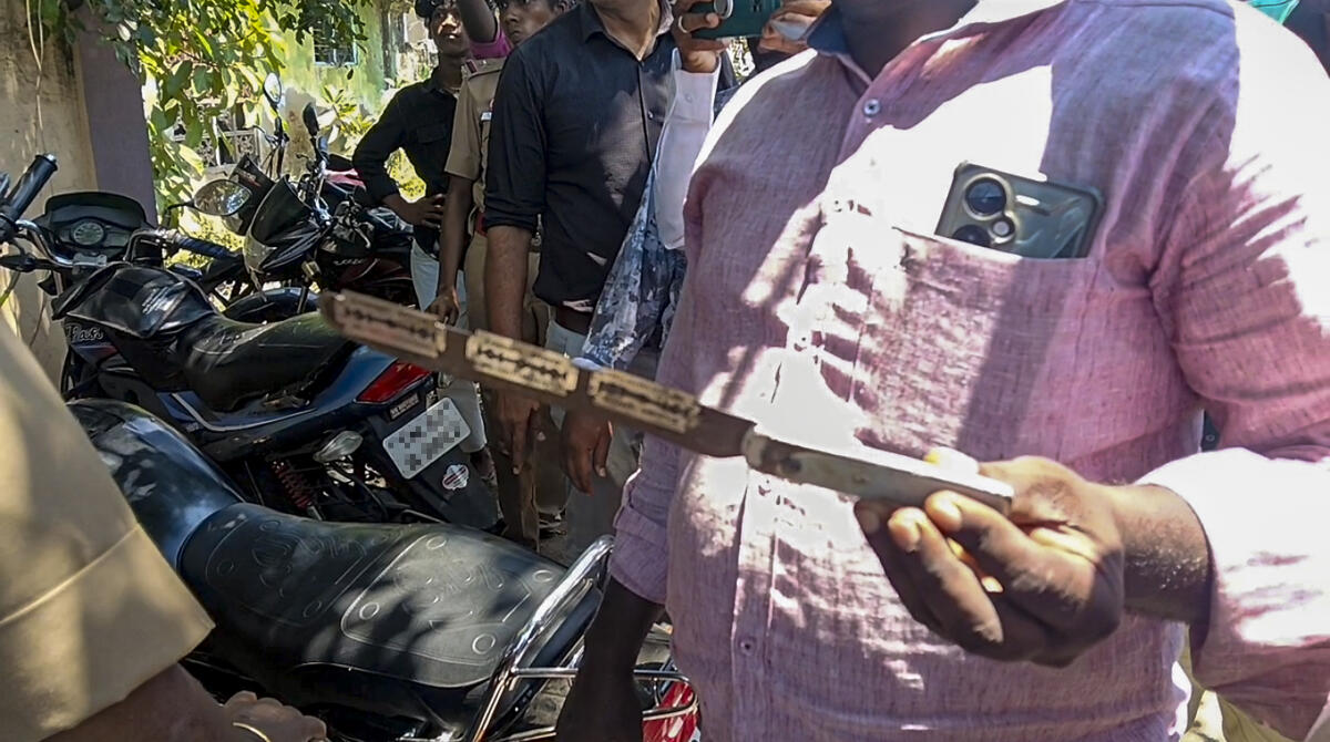 A man shows an object which was allegedly used in the stabbing of a police official during the Tamil Nadu Assembly elections, at a polling station at Poompuhar constituency, in Mayiladuthurai district.
