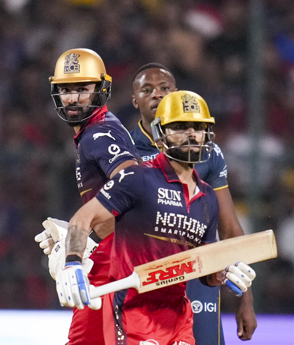 Royal Challengers Bengaluru's Devdutt Paddikal, left, and Virat Kohli run between the wickets during an Indian Premier League (IPL) 2026 T20 cricket match between Royal Challengers Bengaluru and Gujarat Titans