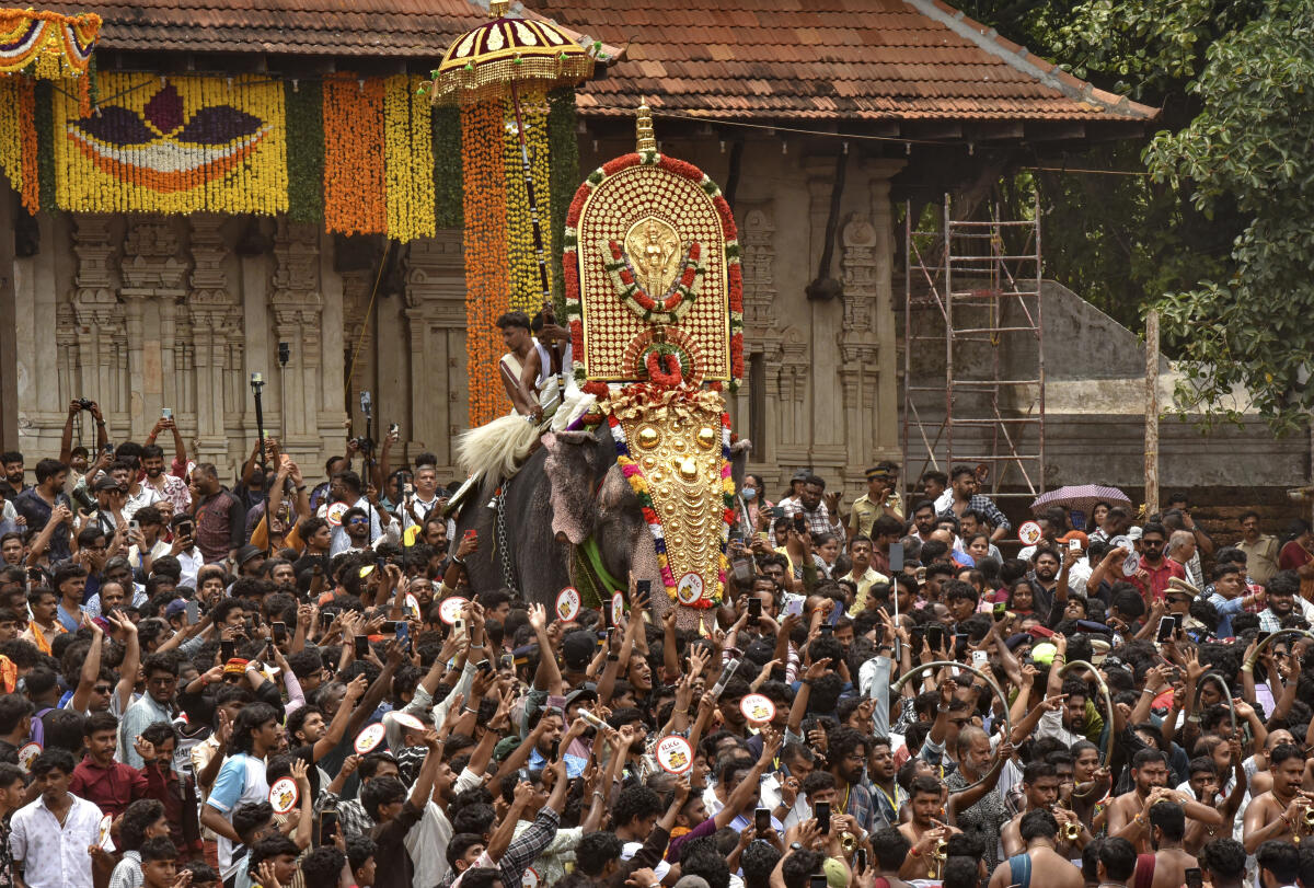 A caparisoned elephant namely 'Ernakulam Sivakumar' opens the door of the southern 'gopuram' to formally announce the beginning of the 'Thrissur Pooram' festival.