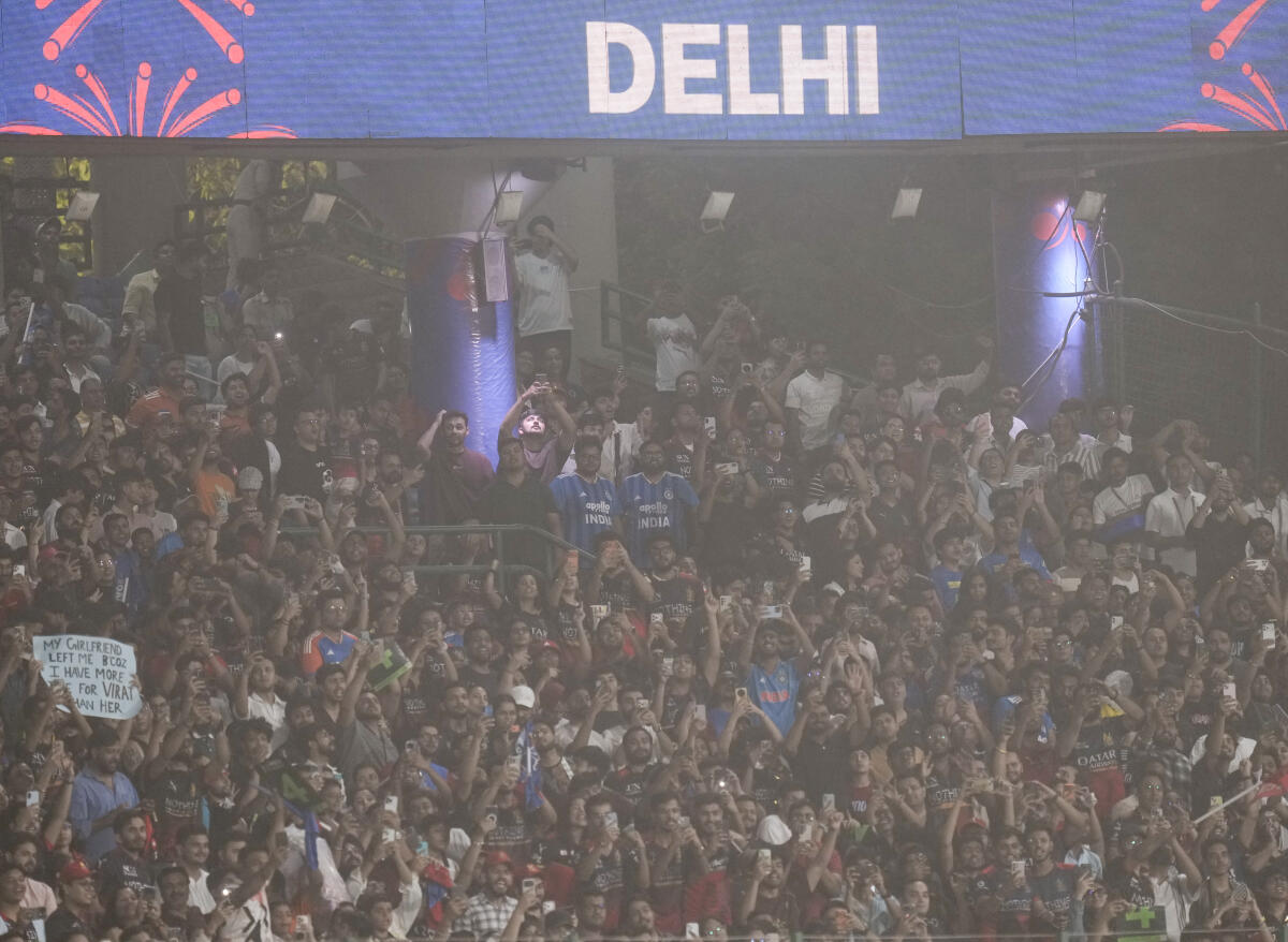 Crowd clicks photographs amid a dust storm during the Indian Premier League (IPL) T20 cricket match between Delhi Capitals and Royal Challengers Bengaluru, in New Delhi, Monday, April 27, 2026. 