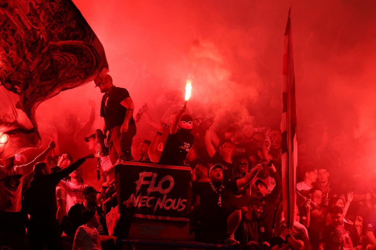 Paris St Germain fans celebrate with flares after Khvicha Kvaratskhelia scores their first goal