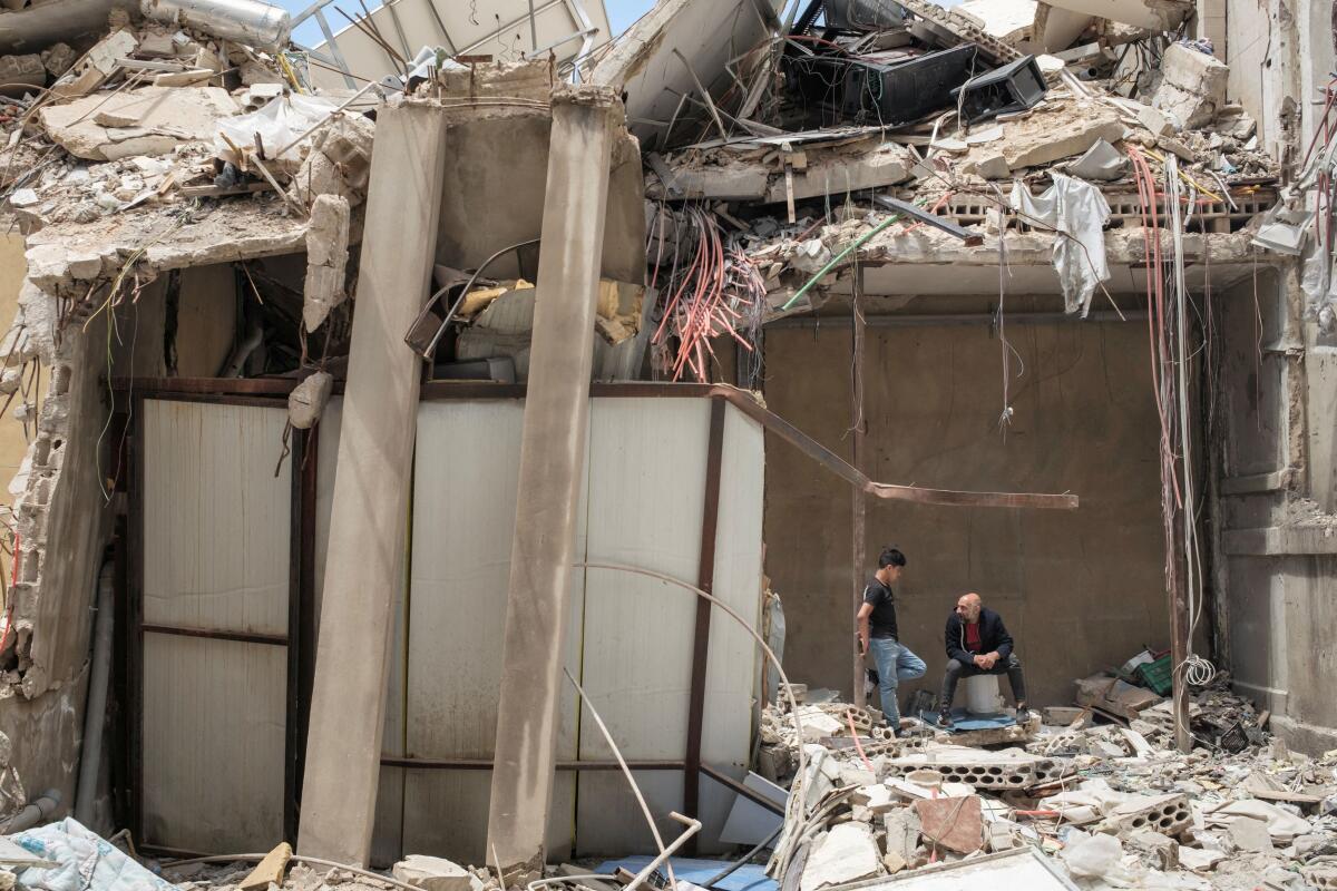 People inside a destroyed building, amid a temporary ceasefire between Lebanon and Israel, in Tyre, southern Lebanon, April 28, 2026.