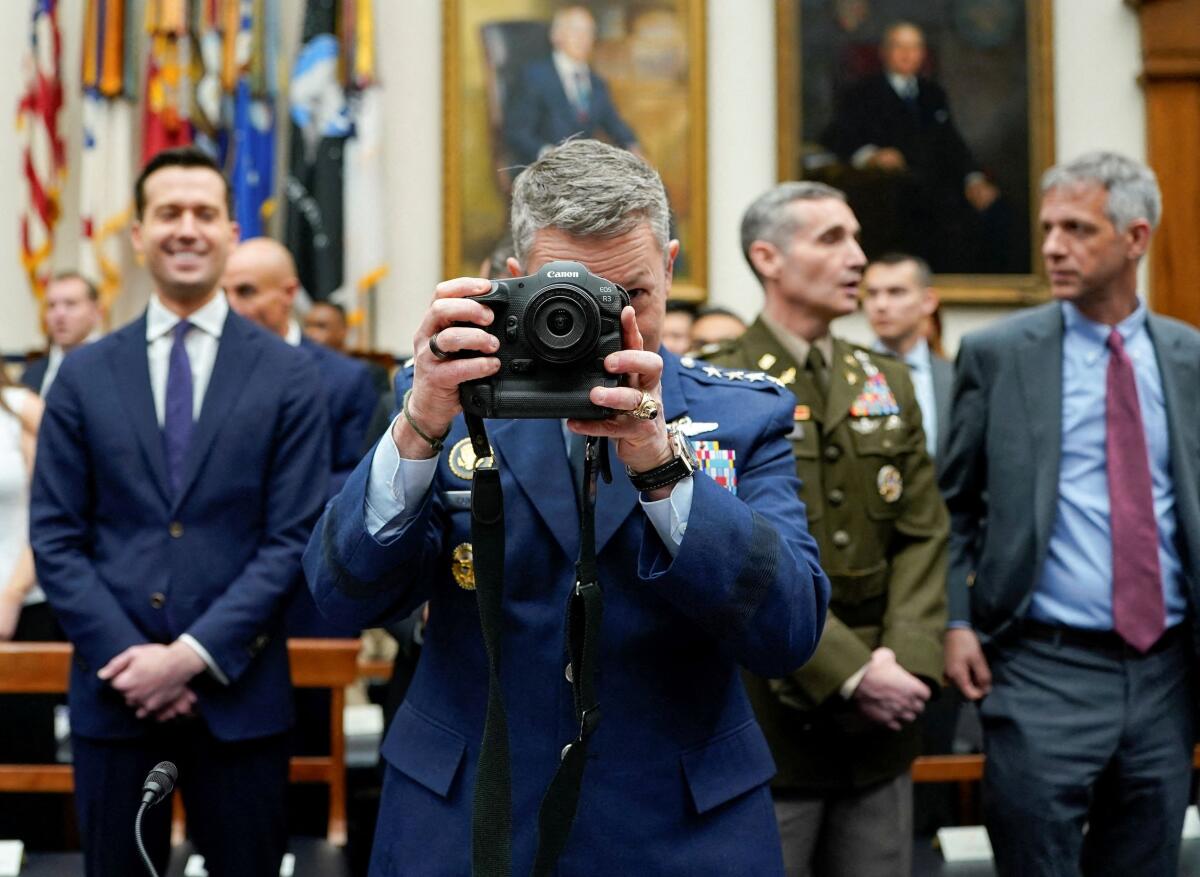 U.S. Chairman of the Joint Chiefs of Staff General Dan Caine uses a camera as he attends a House Armed Services Committee hearing on the Department of Defense's FY27 budget request on Capitol Hill in Washington, D.C., U.S., April 29, 2026.