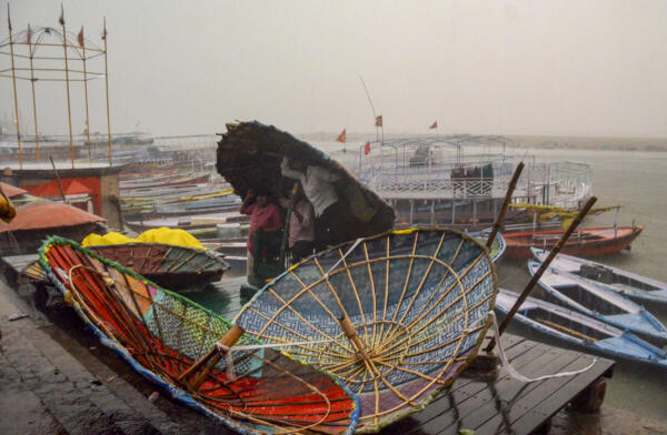 People take cover under a makeshift shed amid strong winds, at a ghat in Varanasi, Uttar Pradesh, Wednesday, April 29, 2026.