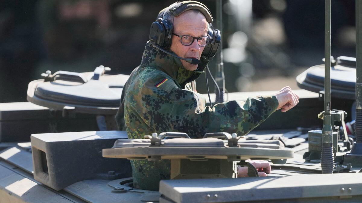 German Chancellor Friedrich Merz rides in a Boxer armoured fighting vehicle during his visit to a Bundeswehr base in Munster, Germany, Thursday, April, 30, 2026. 