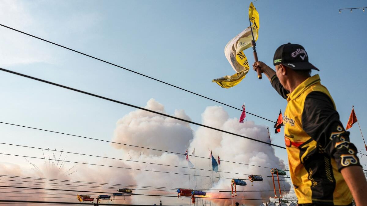 People take part in the annual "Look Noo" rocket-launching competition, a tradition of the ethnic Mon community in which rockets packed with explosives are tethered to cables and fired toward pagoda-shaped targets to honor deceased Buddhist monks, and in some areas form part of Songkran celebrations, in Pathum Thani province on the outskirts of Bangkok, Thailand, May 3, 2026.