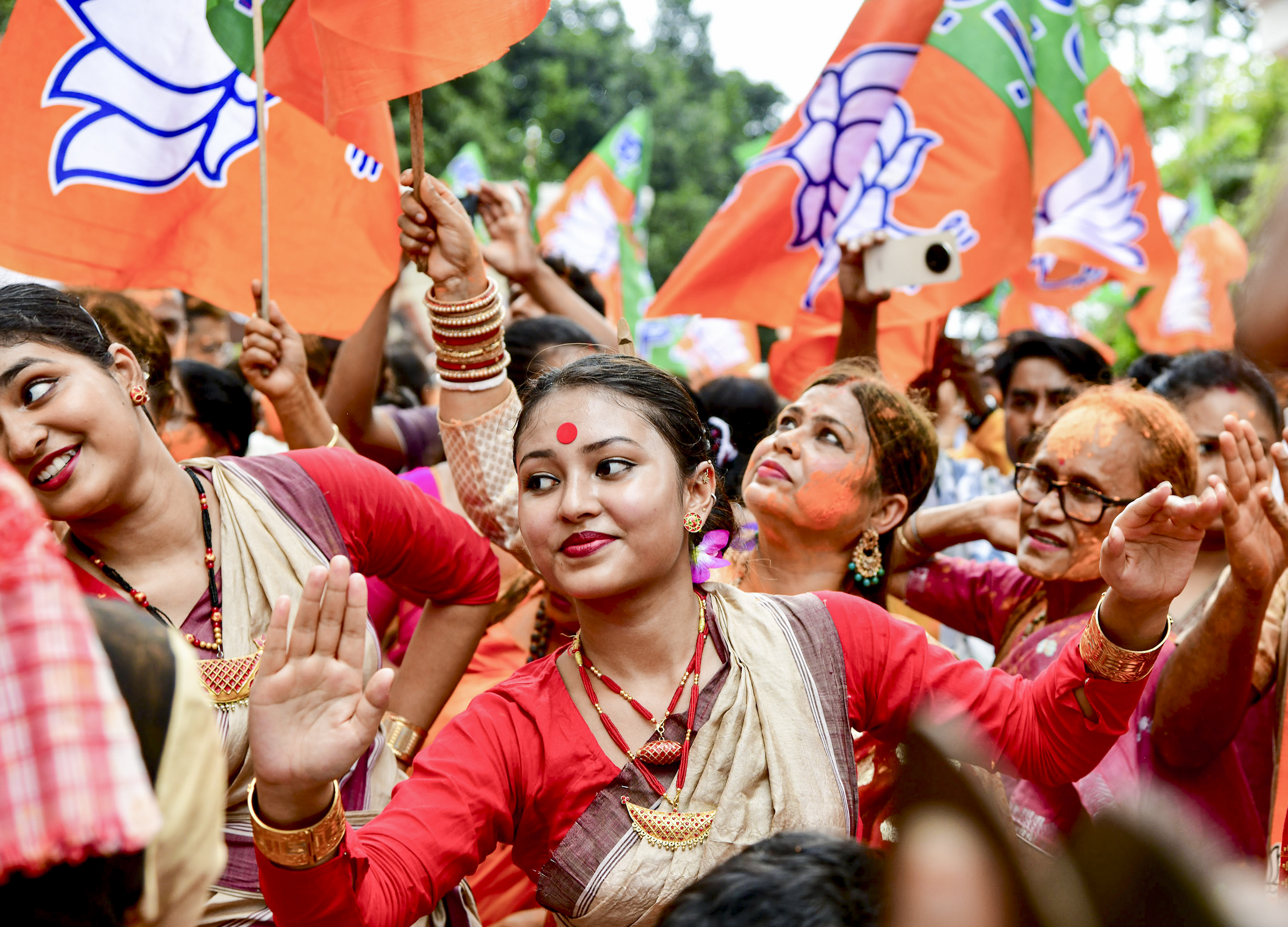 Artistes perform after the BJP retains power in Assam on Monday. PTI