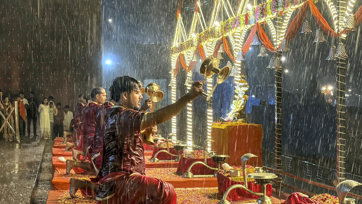 Priests perform Ganga 'Aarti' during heavy rainfall at Dashashwamedh Ghat, in Varanasi, Uttar Pradesh, Monday, May 5, 2026.