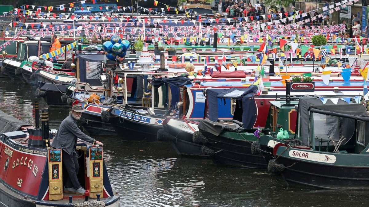A boater steers a narrow boat during the Canalway Cavalcade waterways three-day festival in Little Venice, London, Britain, May 4, 2026.