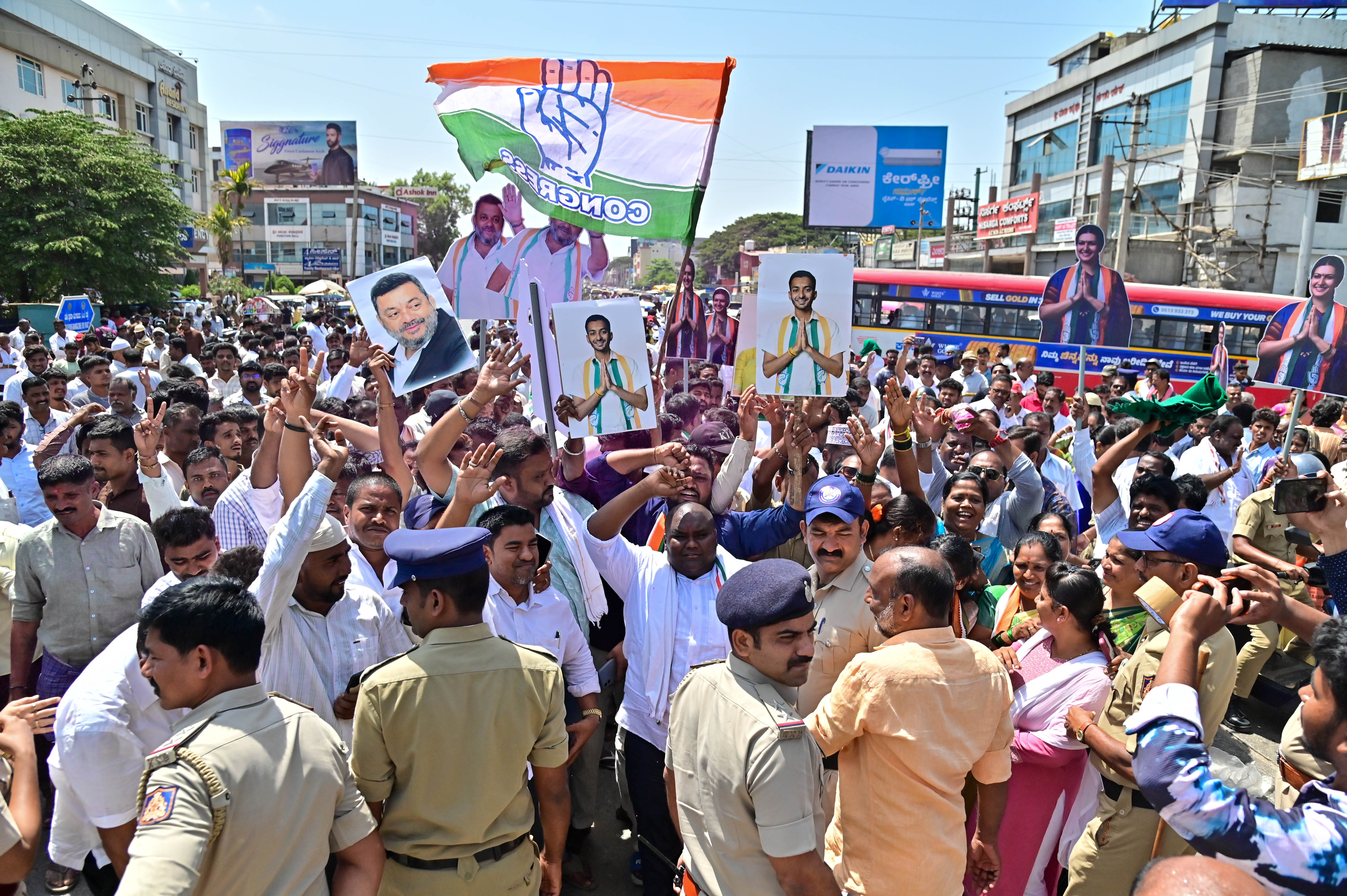 Congress workers celebrate the victory of party candidate Samarth Shamanur in the bypolls to Davangere South Assembly constituency. 
