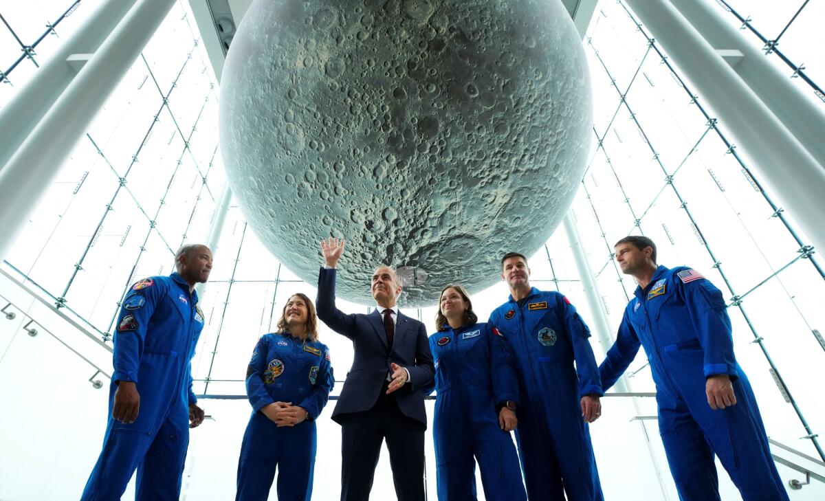 Canadian Prime Minister Mark Carney stands with crew members of the Artemis II mission at the Museum of Nature in Ottawa, Ontario, Canada.