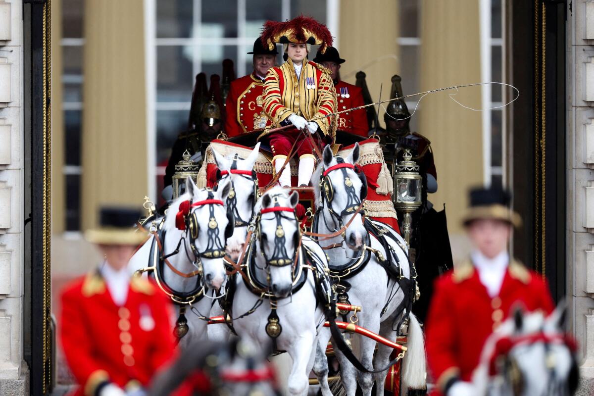 A carriage transporting the Imperial State Crown leaves Buckingham Palace on the day of the State Opening of Parliament in London, Britain.