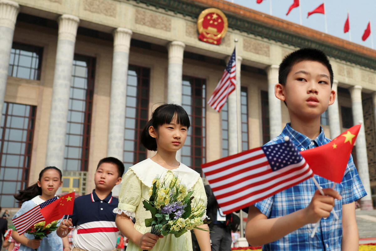 Children hold Chinese and US flags before the welcome ceremony for US President Donald Trump by Chinese President Xi Jinping in Beijing.