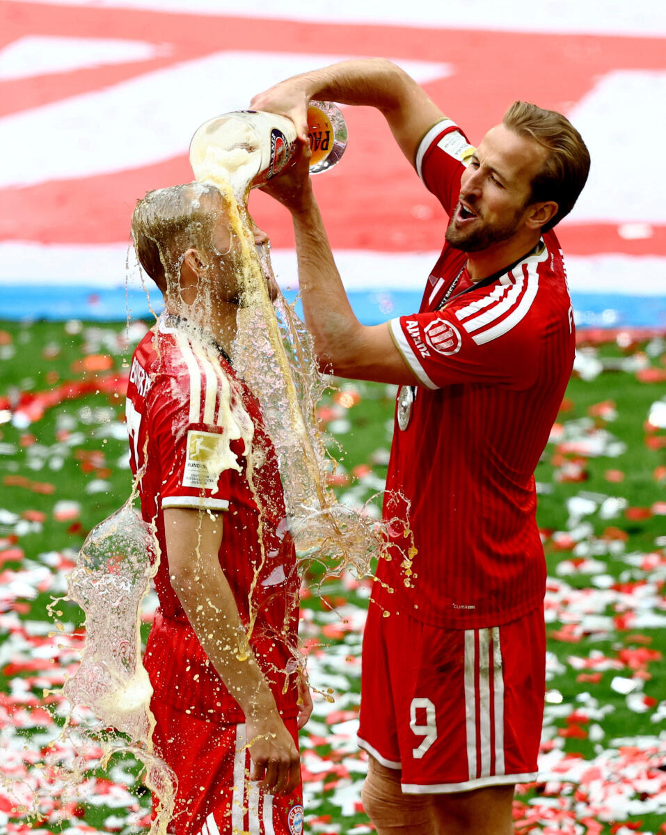 Bayern Munich's Harry Kane pours beer over Konrad Laimer to celebrate winning the Bundesliga.