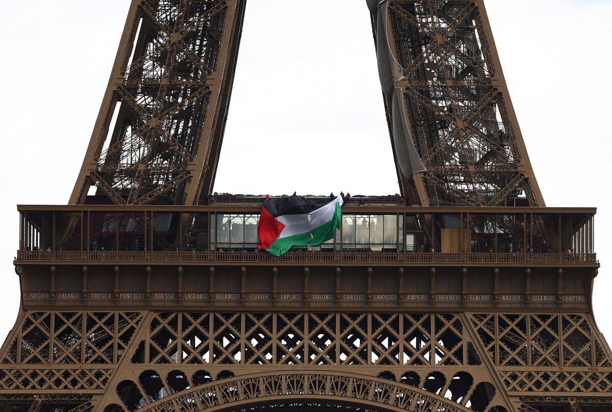 Activists unfurl a large Palestinian flag from the Eiffel Tower in Paris, France.