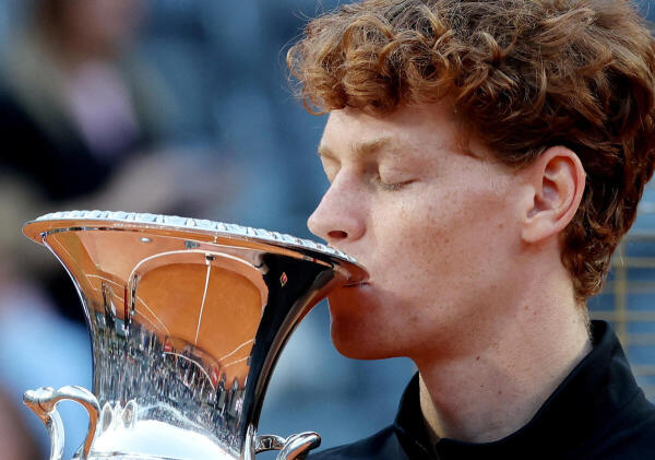 Italy's Jannik Sinner celebrates with the trophy after winning his men's final match against Norway's Casper Rudd