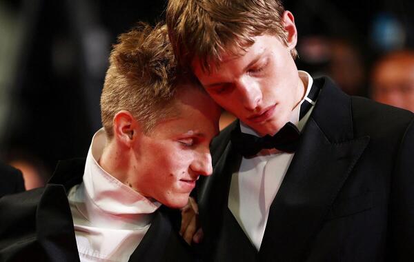 Cast members Emmanuel Machia and Valentin Campagne pose on the red carpet during arrivals for the screening of the film "Coward" in competition at the 79th Cannes Film Festival in Cannes, France.