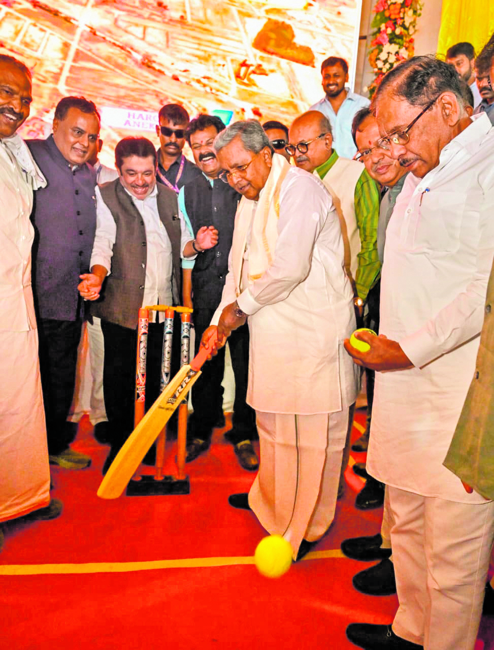 Taking a fresh guard Chief Minister Siddaramaiah shows his batting skills on the sidelines of laying for new stadium at Anekal on Saturday. 