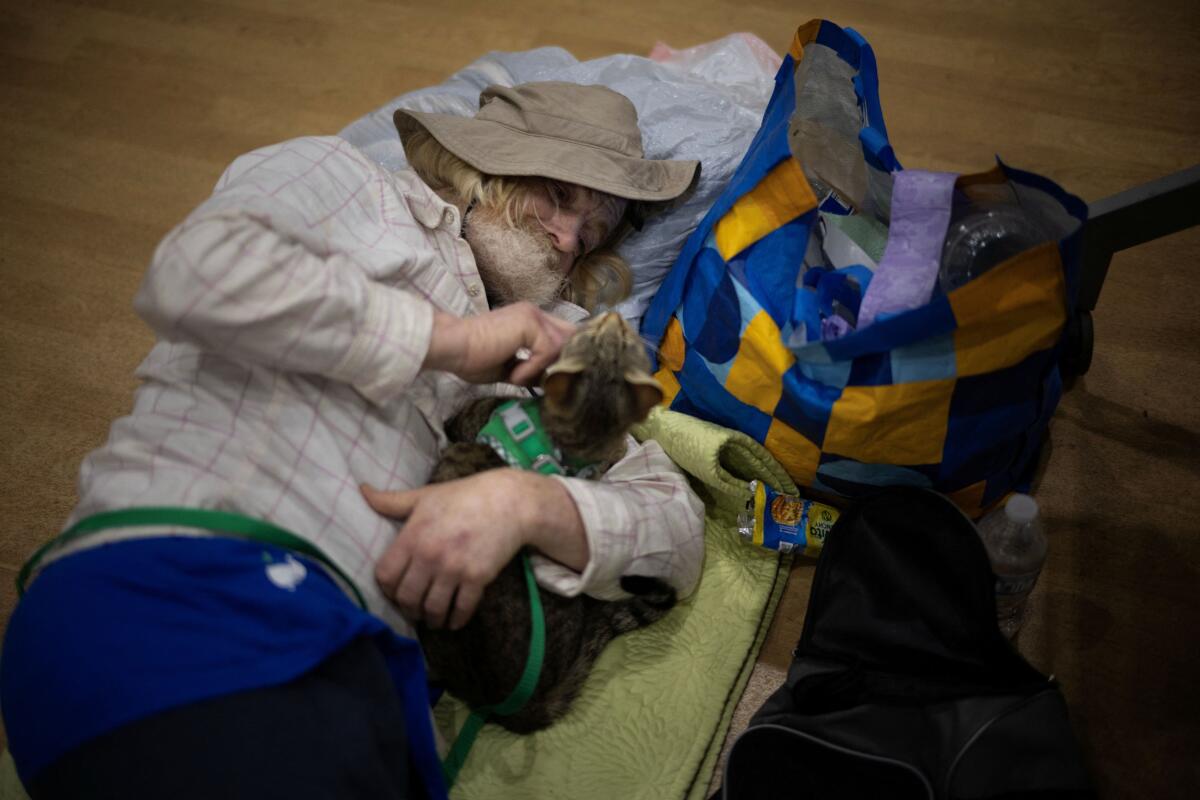 Don Heard, from Stanton, and his cat Roweida, rest at a temporary shelter in Fountain Valley, California, following their evacuation prompted by a failing chemical tank containing methyl methacrylate, a flammable liquid used in the aerospace industry, in nearby Garden Grove, California, US.