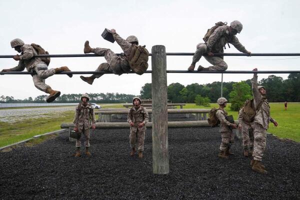 Recruits climb over a pair of bars as U.S. Marine recruits take part in the crucible, a 54 hour grueling exercise, one of the last exercises they have to complete before getting pinned as Marines at Parris Island, South Carolina, US.