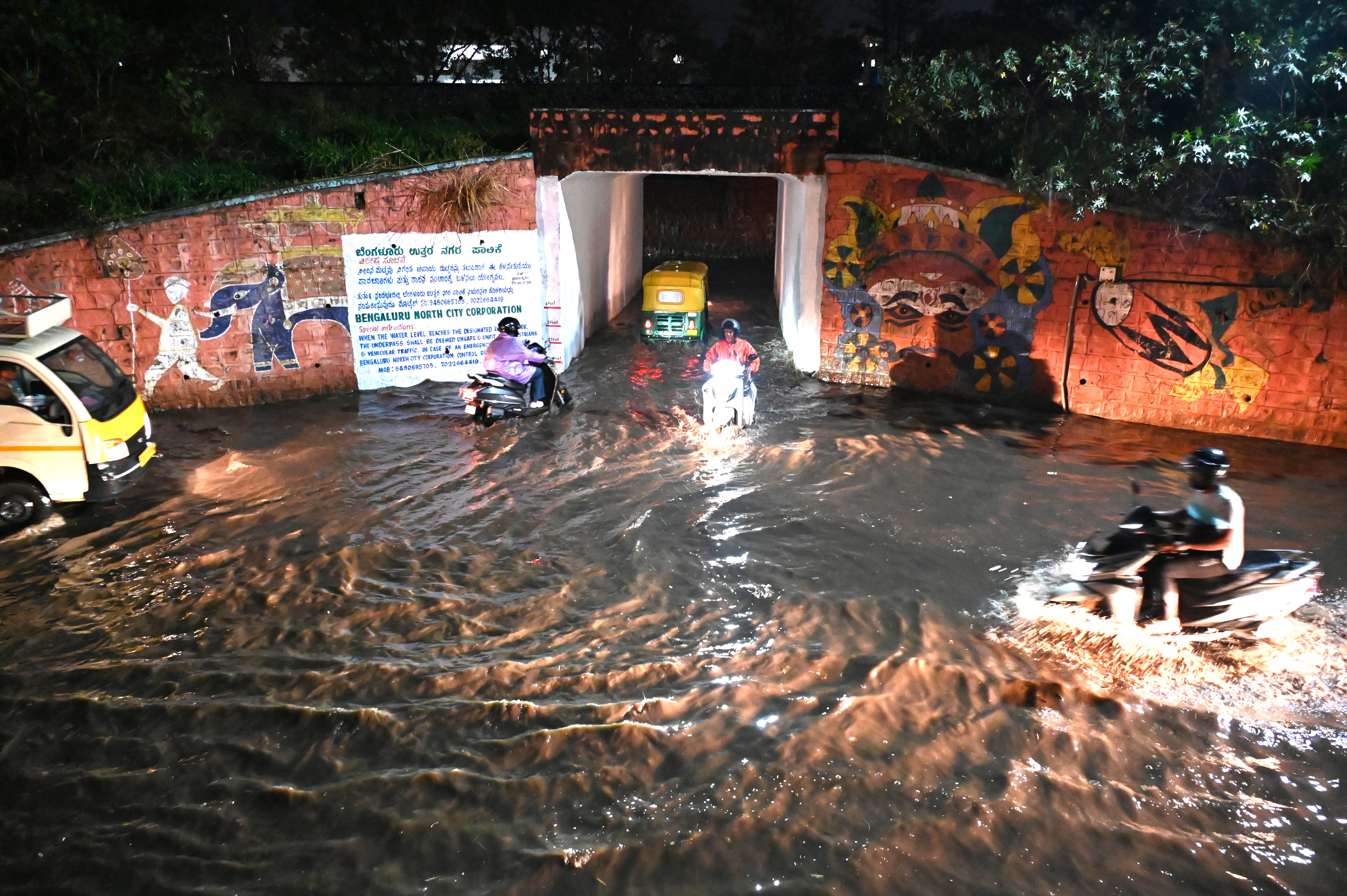 A waterlogged railway underpass at RMV 2nd Stage and a fallen tree branch blocking a main road in Sanjaynagar on Tuesday. 