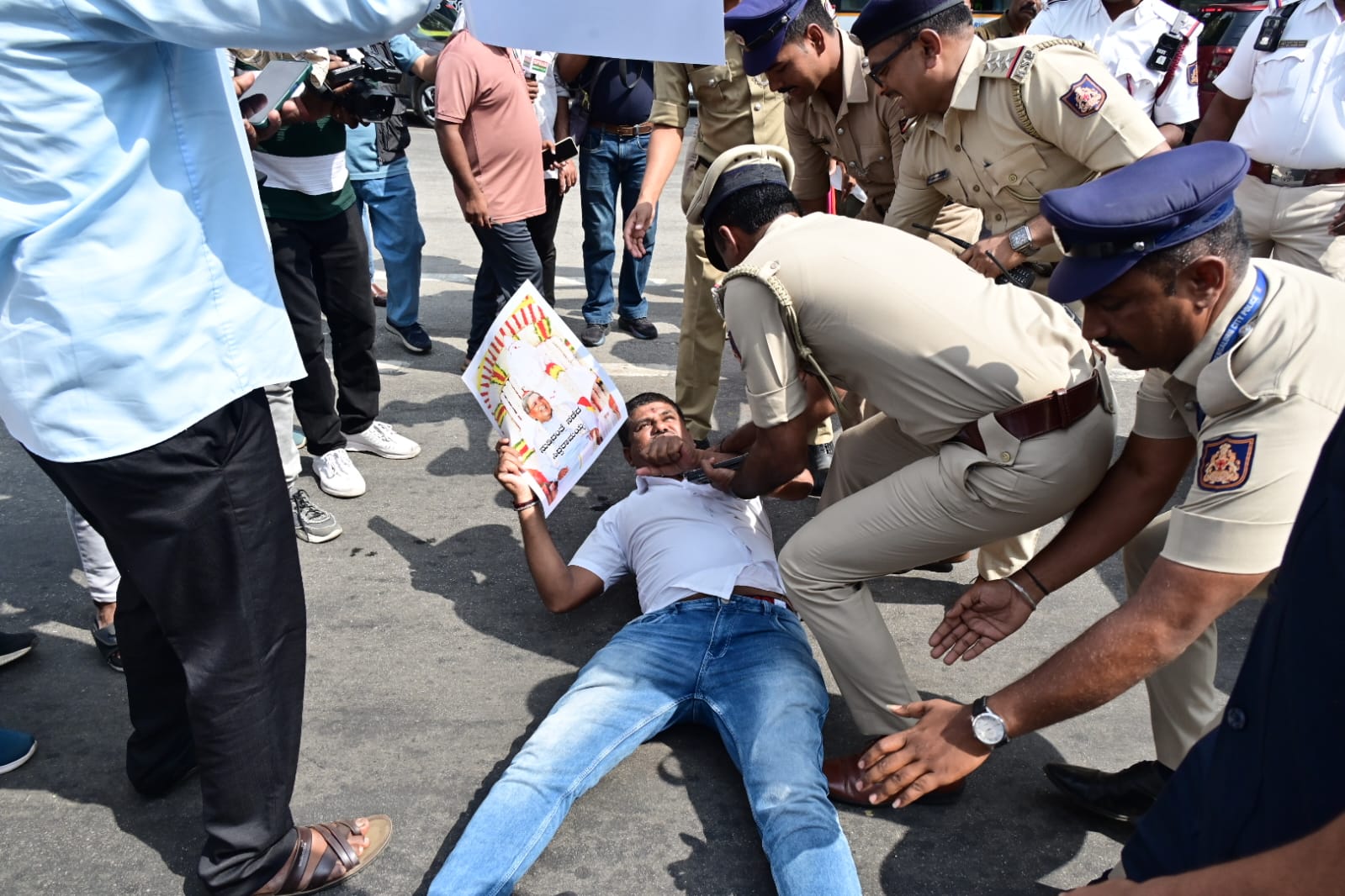 Police removing a protestor lying on the road. 