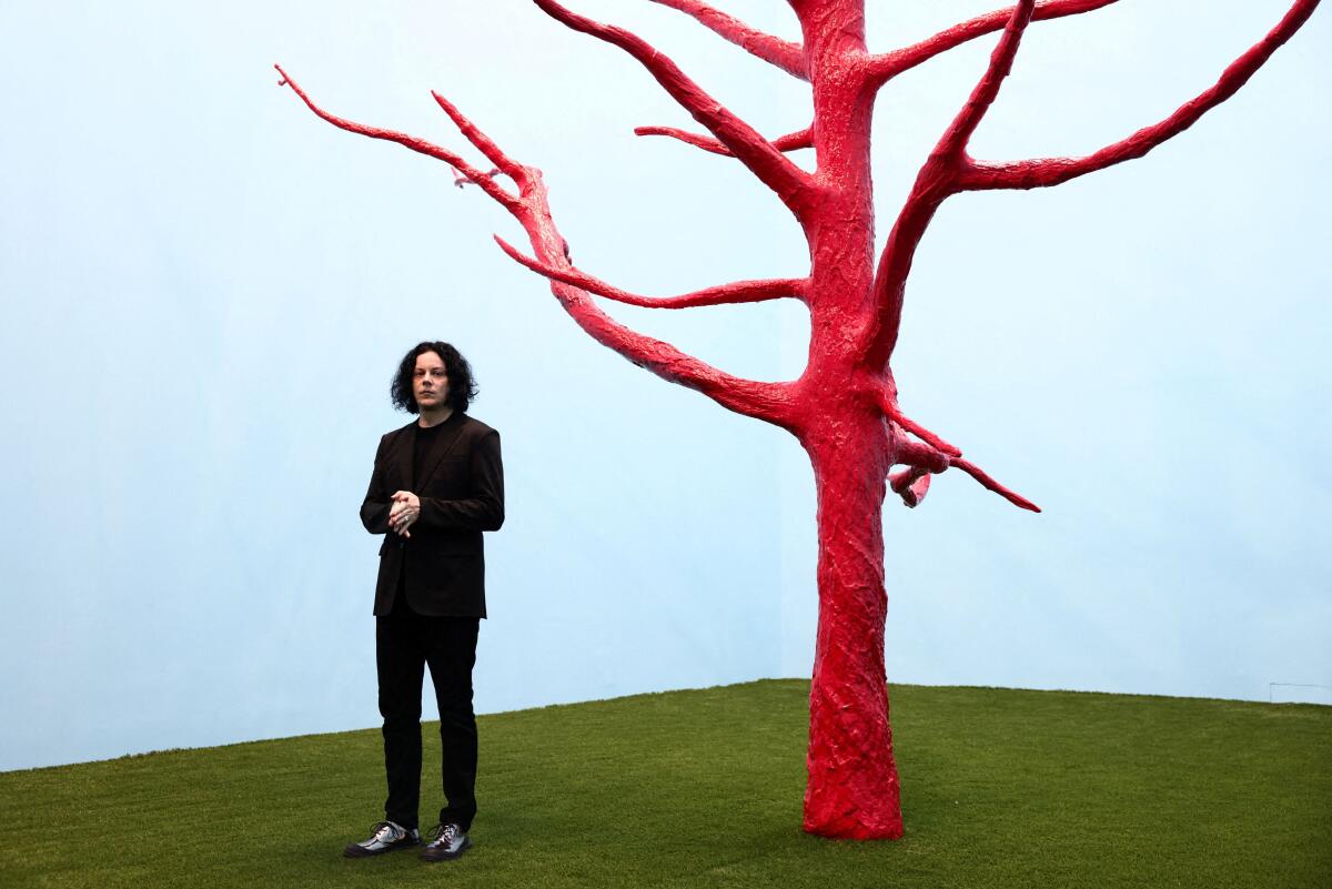 American musician Jack White, guitarist and lead vocalist of the rock duo The White Stripes, poses with 'The Red Tree' (2026) during a photo call launching his "Jack White: These Thoughts May Disappear" exhibition at Newport Street Gallery in London, Britain.