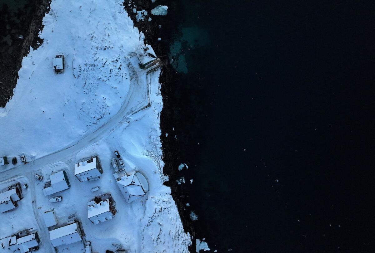 A drone view shows houses on the shore of Nuuk, Greenland.