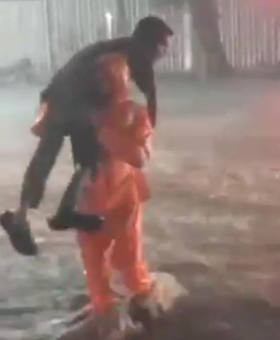 Anil Kumar a traffic police constable carries the differently abled during heavy rains on Friday. 