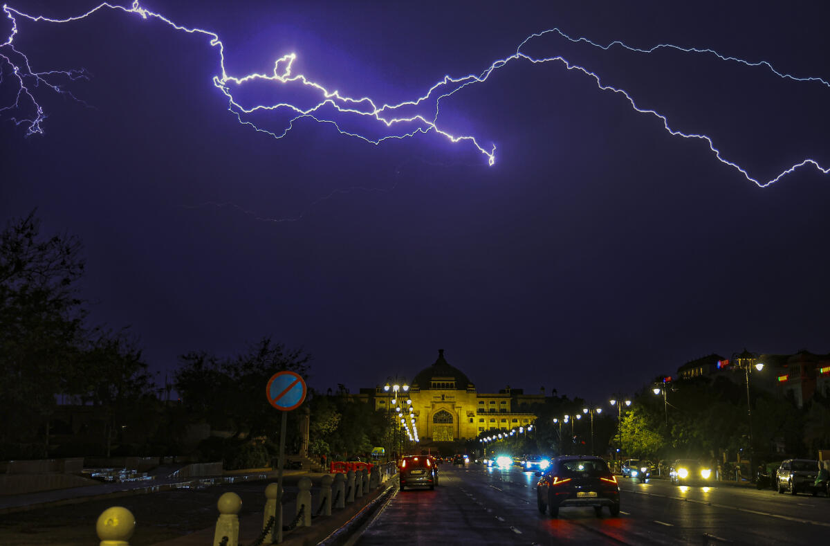 Lightning streaks across the sky over the Rajasthan Assembly, in Jaipur, Rajasthan.
