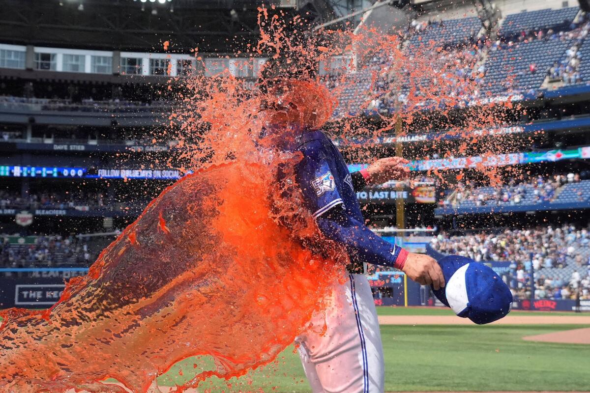 Toronto Blue Jays third baseman Kazuma Okamoto (7) gets doused a second time with Gatorade after a win over the Miami Marlins at Rogers Centre.