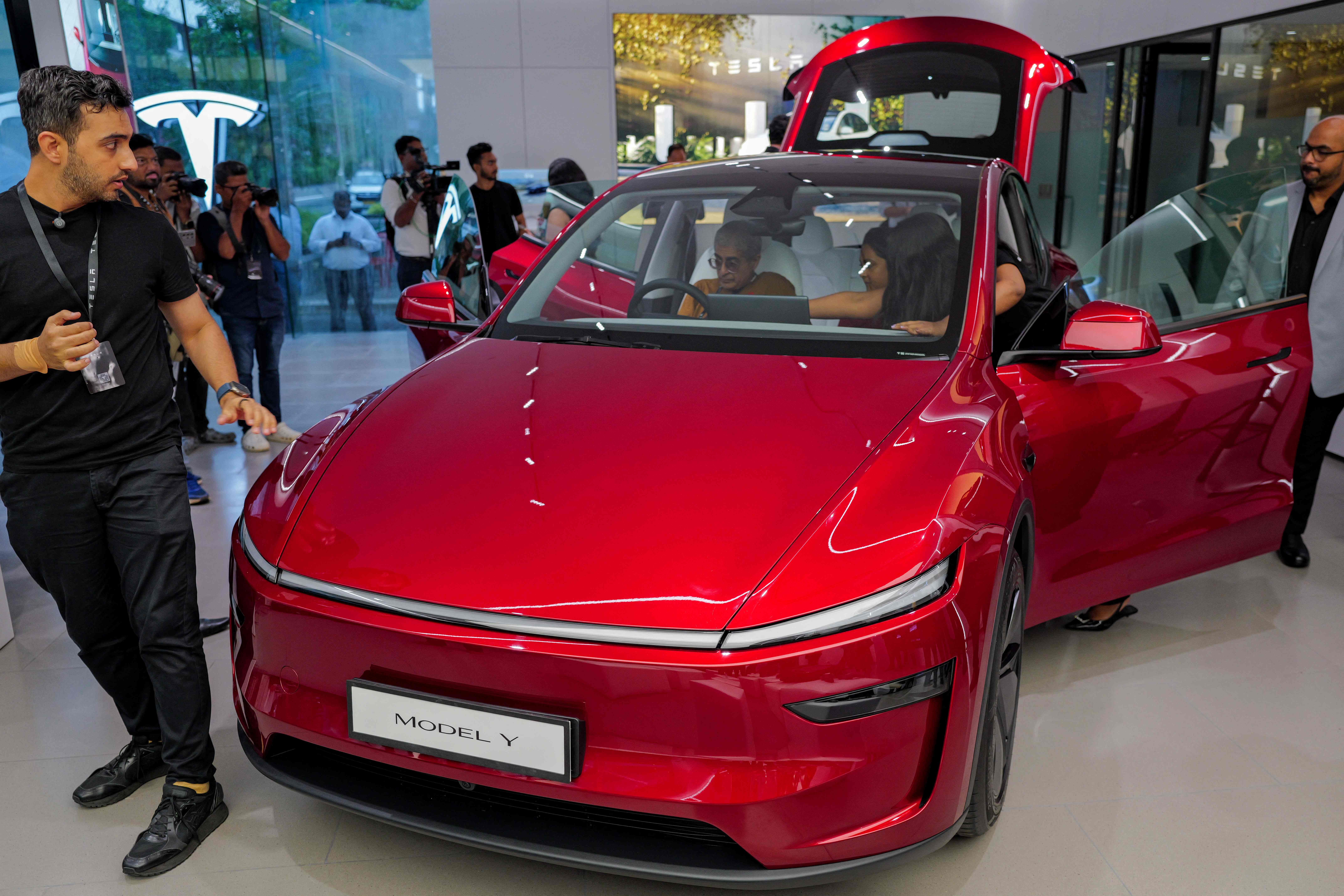 Media personnel inspect Tesla