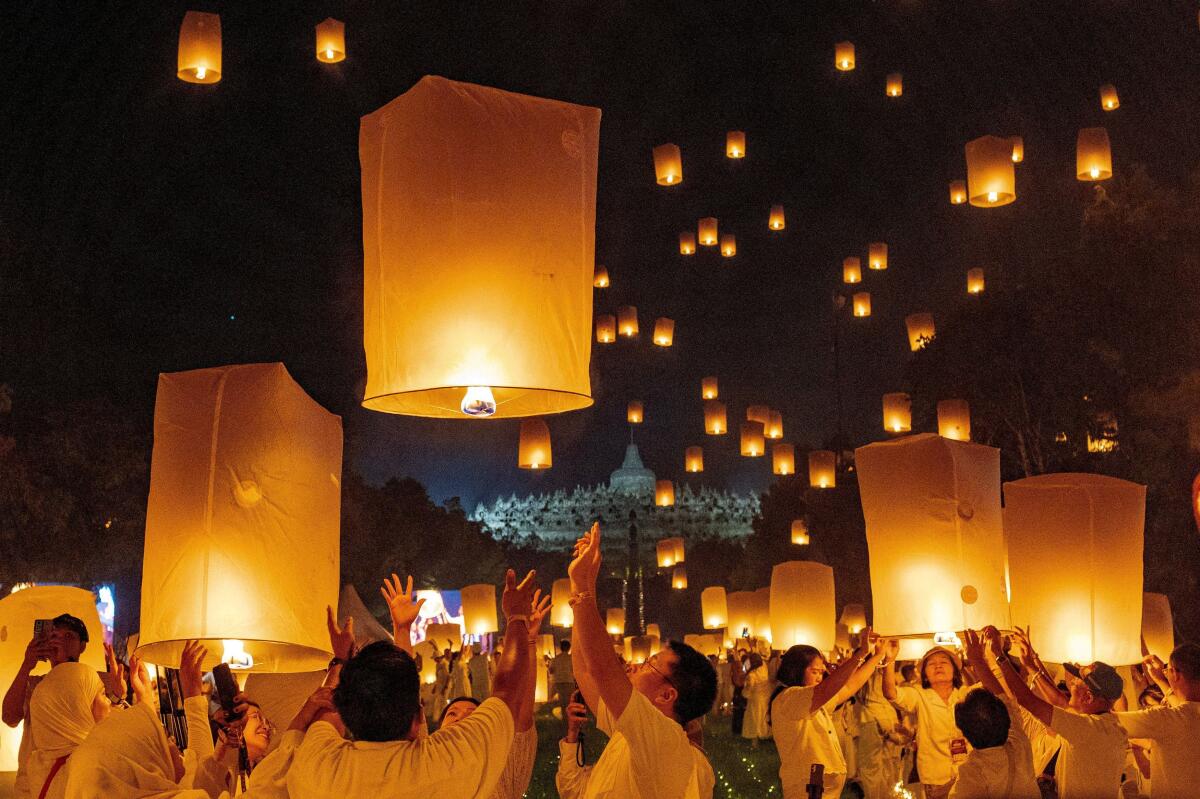 People release paper lanterns during a ceremony on Vesak Day, an annual celebration of the Buddha's birth, enlightenment, and passing, at Borobudur temple in Magelang, Central Java province, Indonesia.