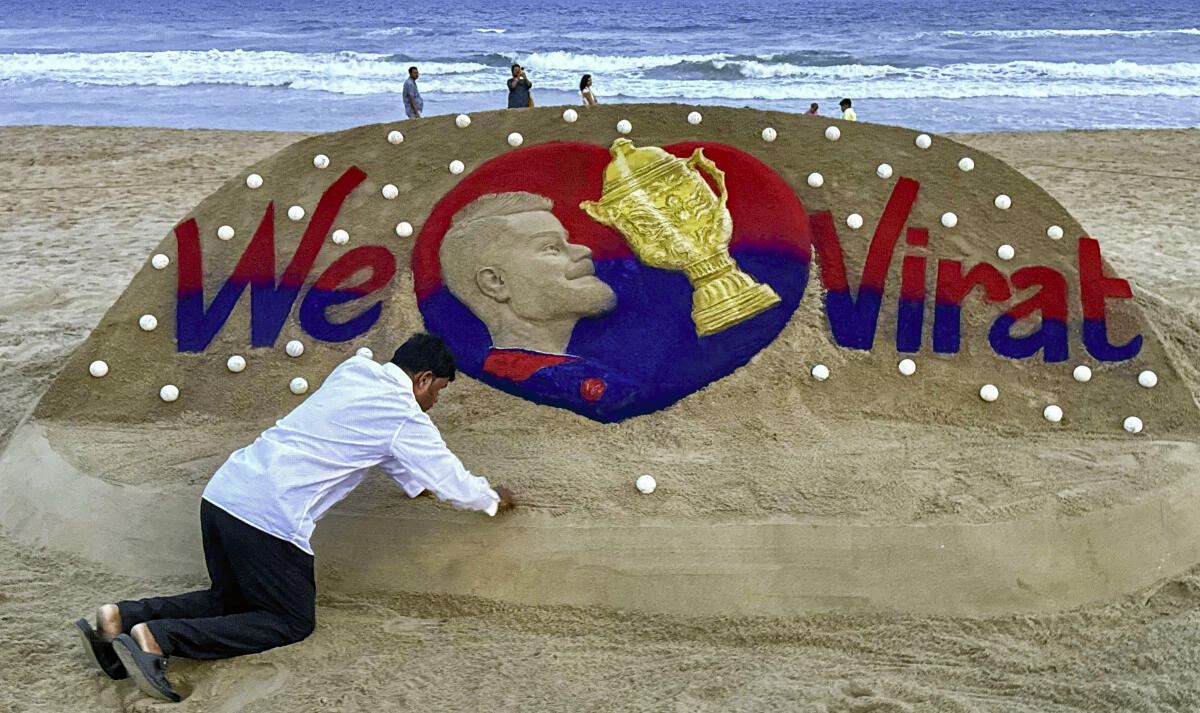A sand sculpture of cricketer Virat Kohli with the message 'We Love Virat' displayed at Puri Beach following Royal Challengers Bengaluru's successful Indian Premier League campaign