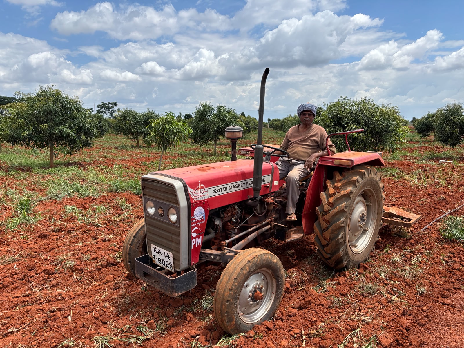 Seventy-two-year-old farmer T V Krishnappa atop his tractor at his farm in Basavapatna on Saturday. Krishnappa who owns three acres of land is preparing his fields to cultivate ragi and beetroot this year.