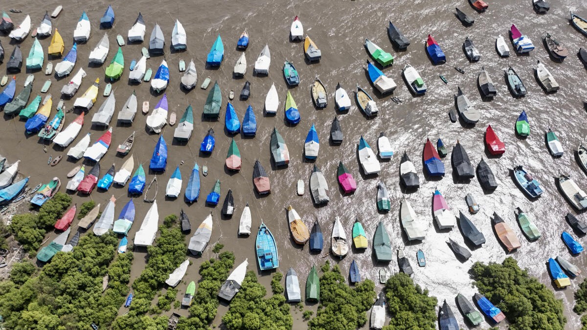 Fishing boats lie moored along the coast of the Arabian Sea during the monsoon fishing ban, at Uttan Beach, near Mumbai, Maharashtra.