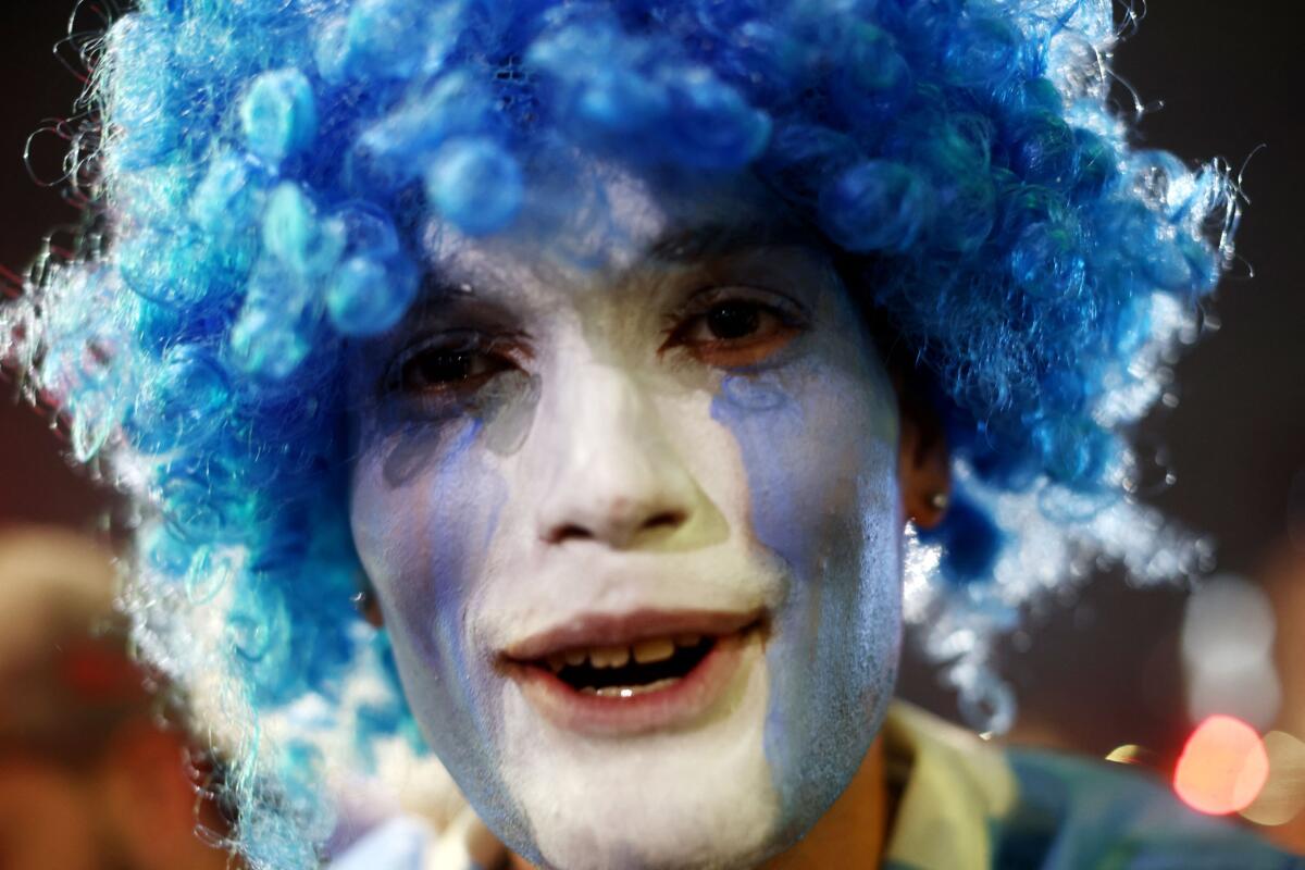 Argentina fan with his face painted in national colors celebrates after Argentina qualified for the World Cup final.