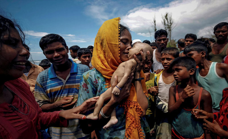 Hamida, a Rohingya refugee woman, weeps as she holds her 40-day-old son after he died as their boat capsized before arriving on shore in Shah Porir Dwip, Teknaf, Bangladesh, September 14, 2017. REUTERS/Mohammad Ponir Hossain