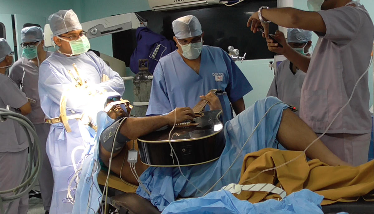 Medics score success with live brain surgery on guitarist... yet again