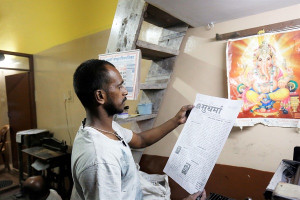 A worker shecks the print.