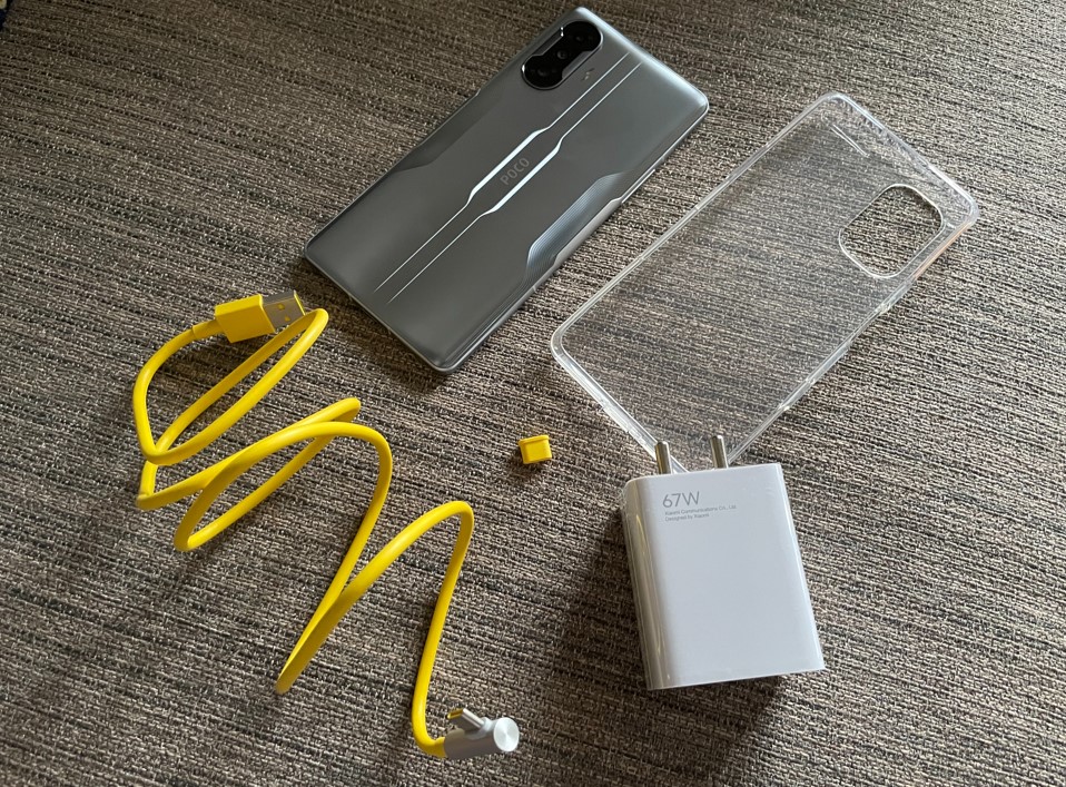 Poco F3 GT with a soft silicone case, a Type-C charger and an adaptor. Credit: DH Photo/KVN Rohit