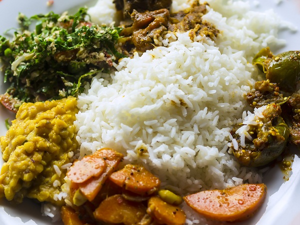 Boiled or steamed rice served with a curry of fish, mutton or chicken, along with other curries made of vegetables, lentils or fruits.