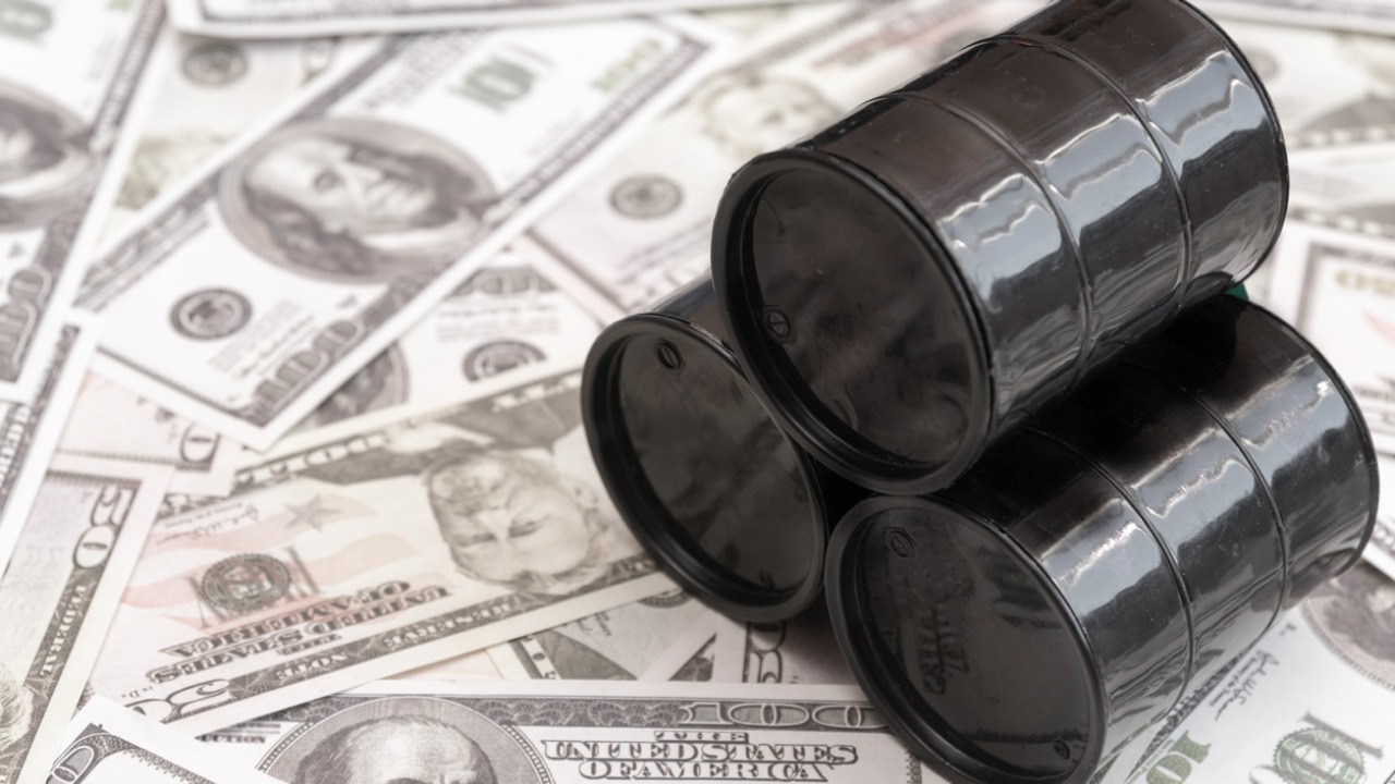 Oil holds near one-month highs as demand forecasts raised