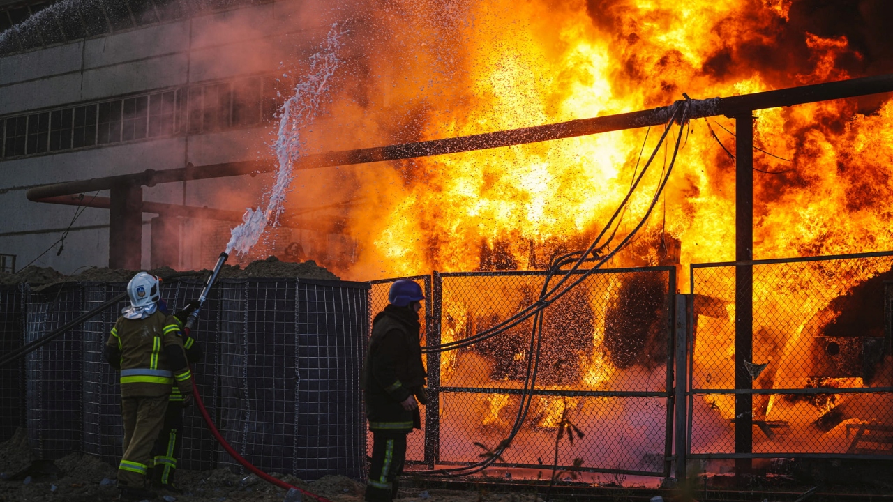 Debris falling on Kyiv, building on fire as air defence active