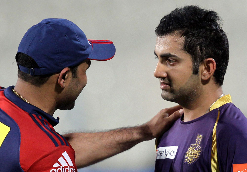 Delhi Daredevils captain V. Sehwag and KKR skipper Gautam Gambhir at the  end of their IPL T20 match at Eden Garden in Kolkata on Thursday night.  PTI Photo