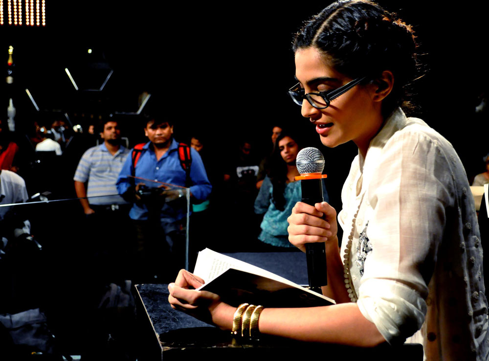 Bollywood actress Sonam Kapoor reads during the unveiling of Khalid Mohamed's book 'Two Mothers' in Mumbai on April 5, 2012. AFP
