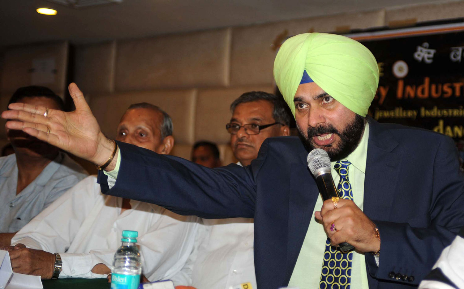 Former cricketer and Bharatiya Janata Party (BJP) member of parliament Navjot Singh Sidhu addresses members of All India Gems and Jewellery Trade Federation and media representatives in Amritsar on April 6, 2012. during a protest against excise dut...