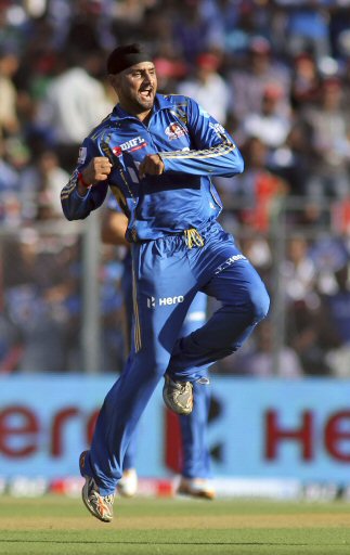 Mumbai Indians' cricketer Harbhajan Singh celebrates the dismissal of Pune Warriors' Bhuvneshwar Kumar during an Indian Premier League (IPL) cricket match in Mumbai, India, Friday, April 6, 2012. (AP Photo/ Rajanish Kakade)